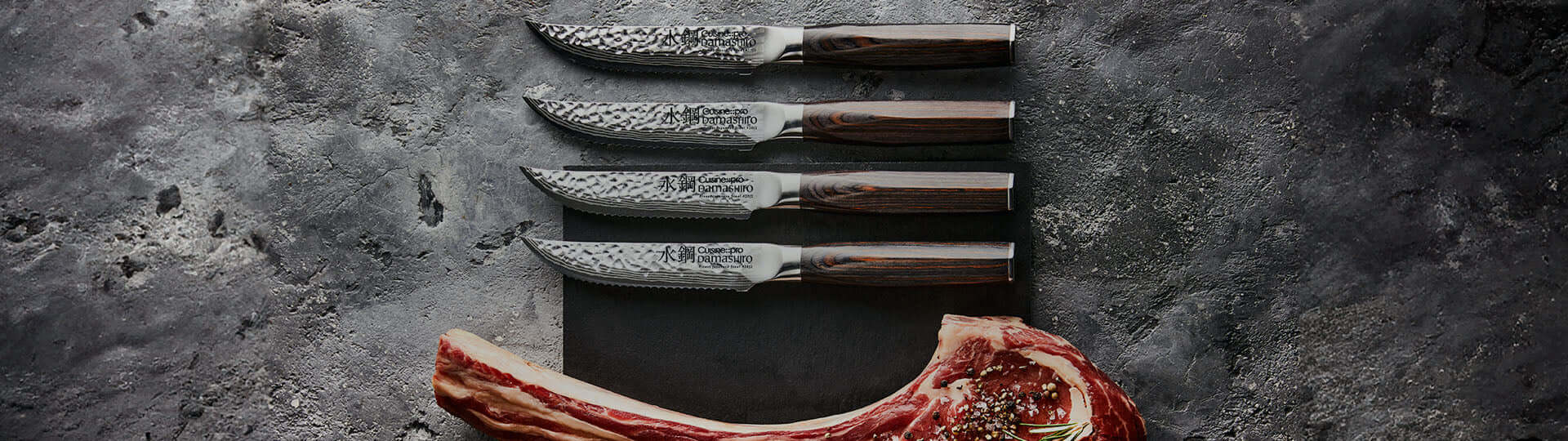 Premium steak knife set with ergonomic handles and a cut steak on a marble surface