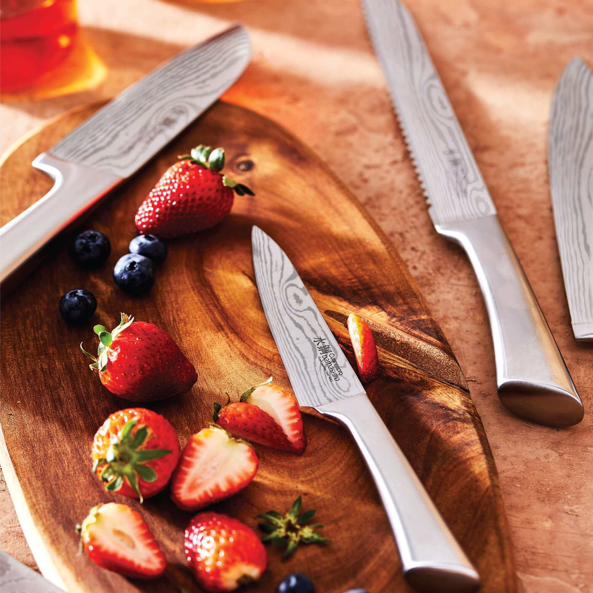 High-quality Japanese knives from Cuisine::pro® Damashiro® Meiyo 7 piece Knife Block with fresh strawberries and blueberries on a wooden board