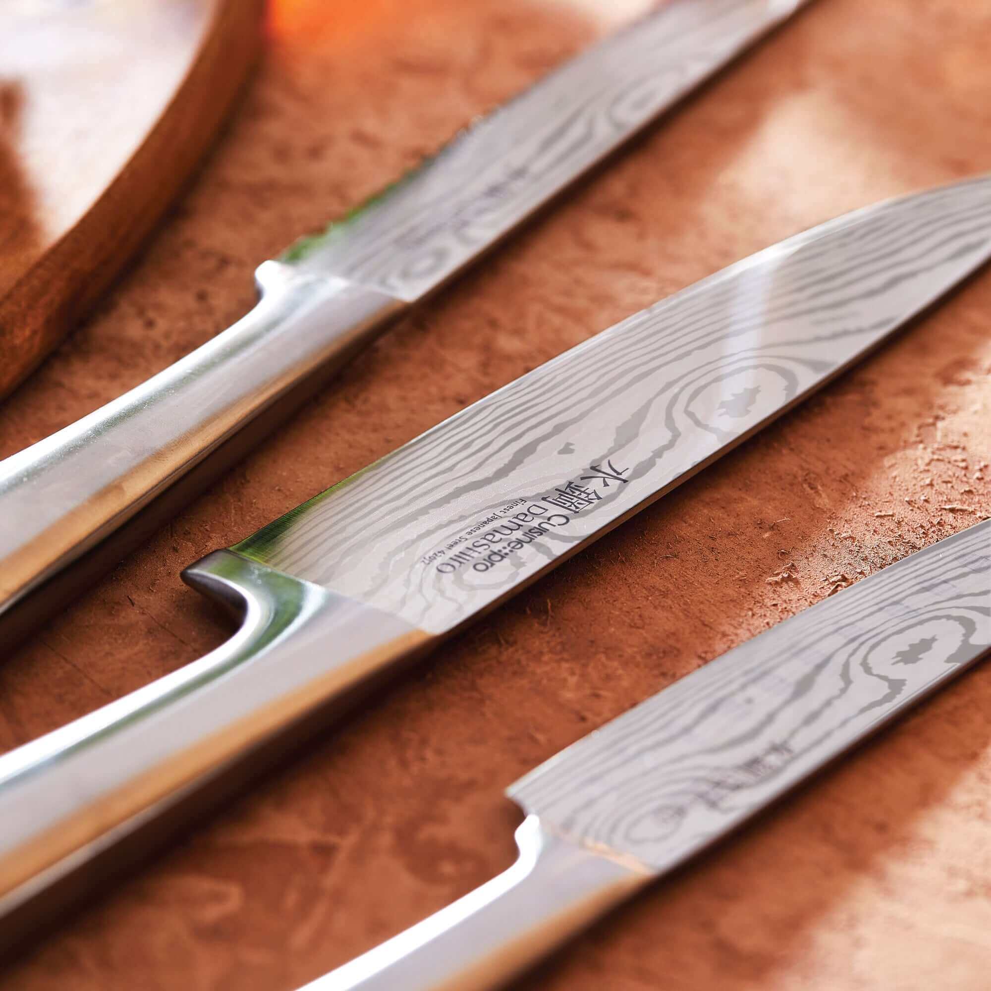 Close-up of Cuisine::pro® Damashiro® Meiyo Japanese steel knives on display showing fine craftsmanship and superior blade quality