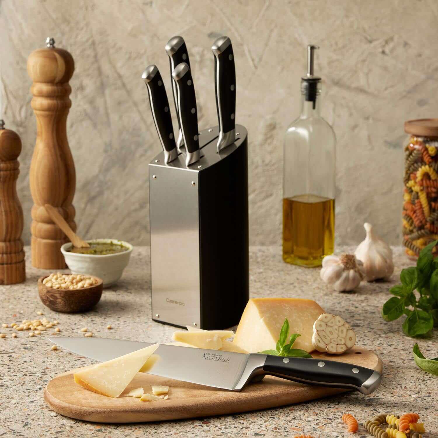 Cuisine::pro® ARTISAN™ Kyoto Knife Block 6 Piece displayed on a kitchen counter with cheese, garlic, and spices.