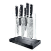 Black-handled knives in a Cuisine pro KIYOSHI Kiyo 7 Piece Knife Block displayed on a black stand with transparent holders.